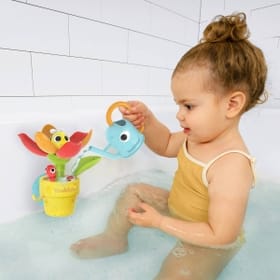 Child in the bath playing with Peek-a-Bee Tub Flower