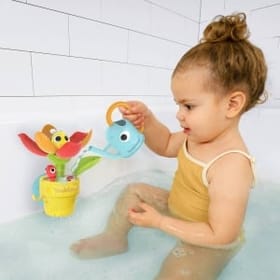 Child in the bath playing with Peek-a-Bee Tub Flower