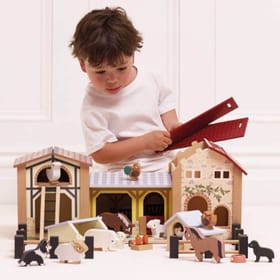 Child with Wooden Farmyard Stables