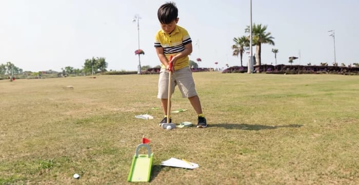 Boy Playing Crazy Golf