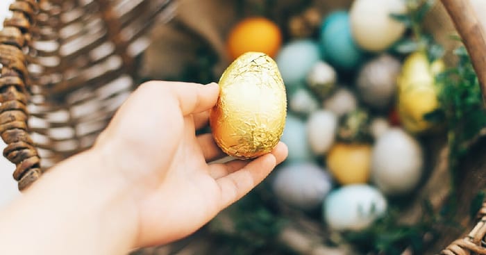 Hand holding golden Easter egg