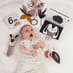 Child Enjoying the Toys in the Black & White Newborn Kit