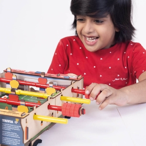 child playing Foosball